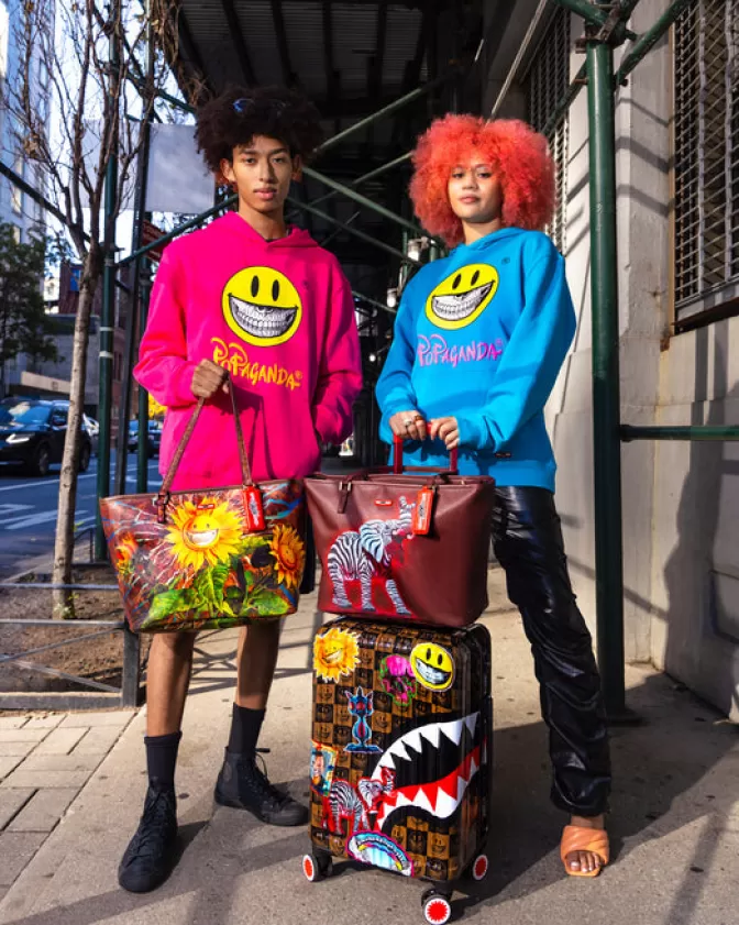 Valigia Cabina Antigurto Sprayground - Edizione Limitata Ron English con Grafiche Pop Art, Bagaglio Rigido da Viaggio Trend del Momento